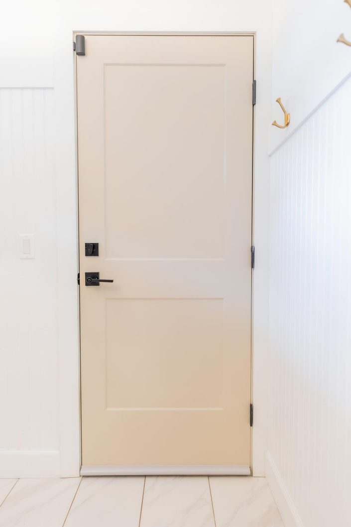 White interior door featuring a ToeSafe bottom door sweep alternative.